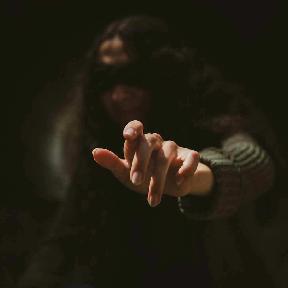 person in black long sleeve shirt with white manicure