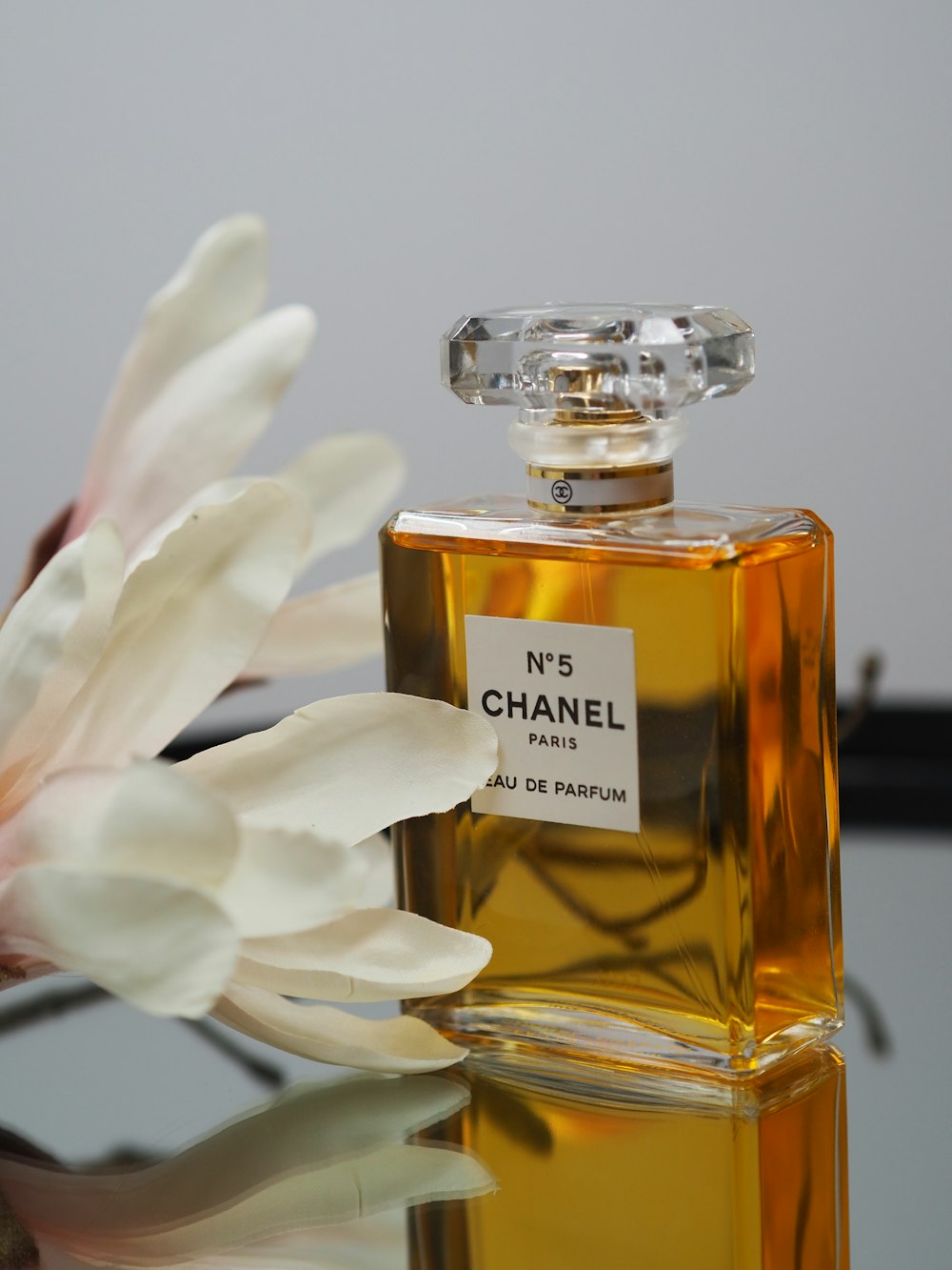 perfume bottle with white flower