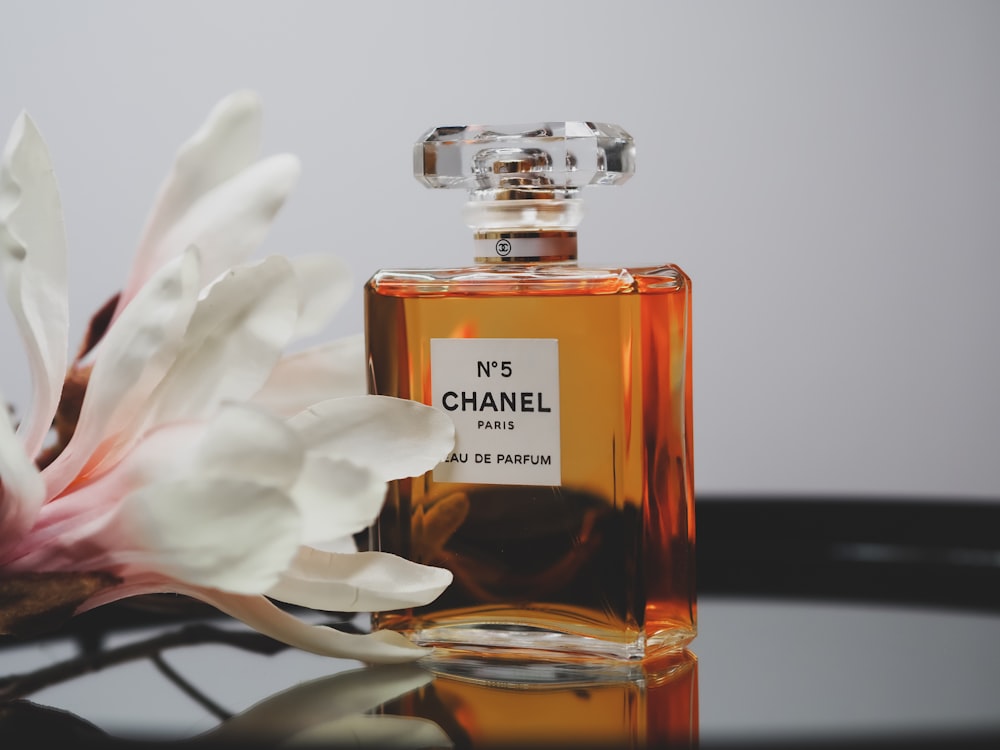 chanel paris perfume bottle on white textile