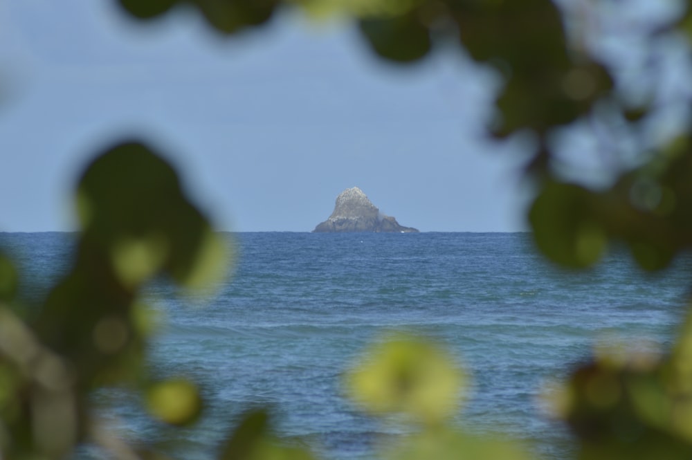 white and black rock formation on sea during daytime