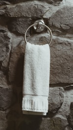 white towel on stainless steel towel holder