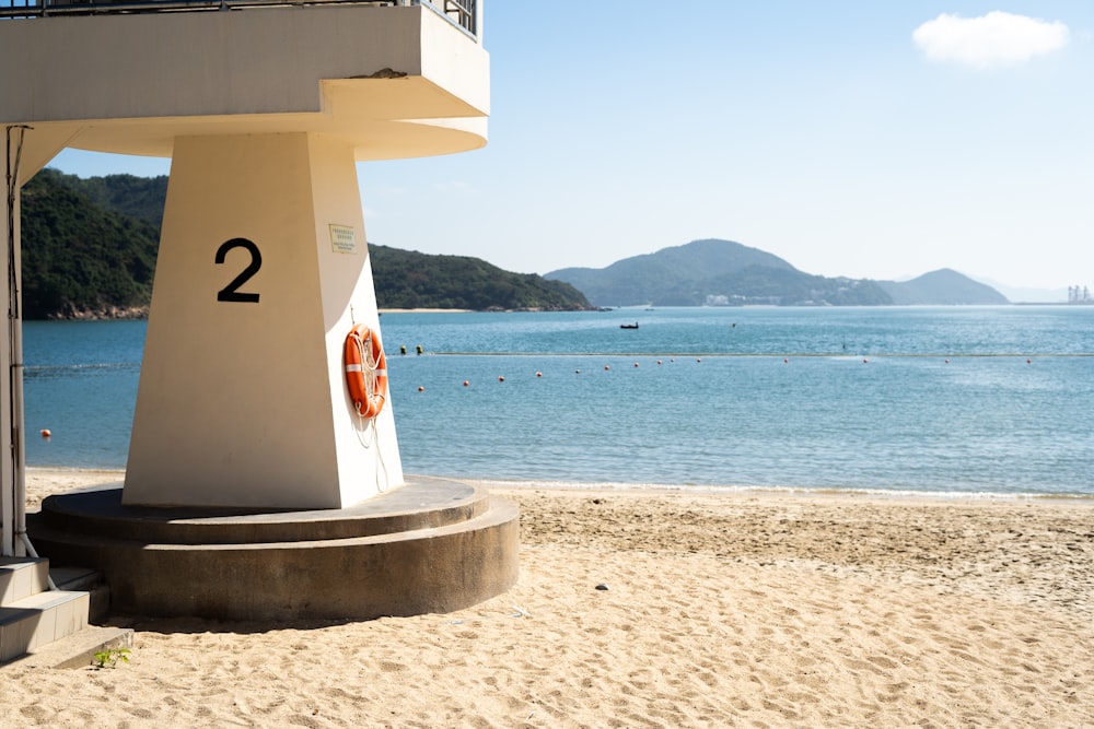 white and red lifeguard tower on beach during daytime