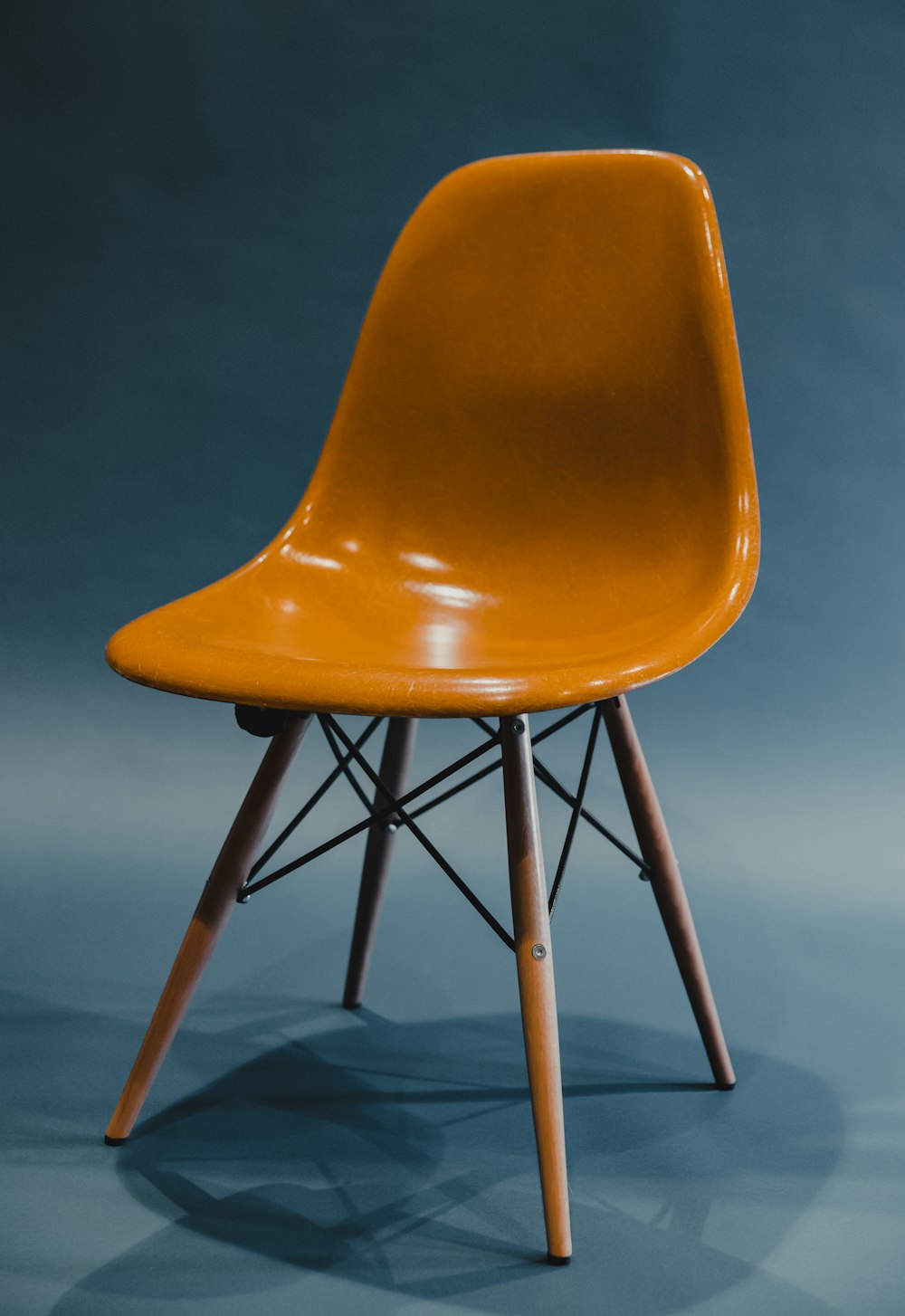 orange and black chair on brown wooden floor