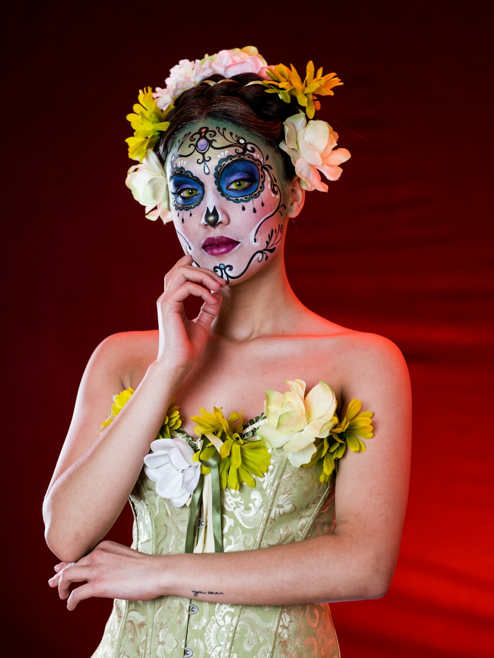 woman with blue and white flower on her face