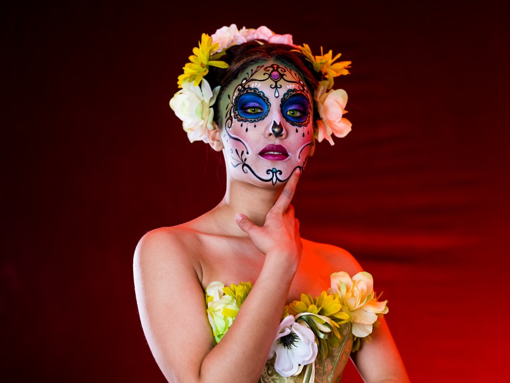 woman with yellow white and red flower on her face
