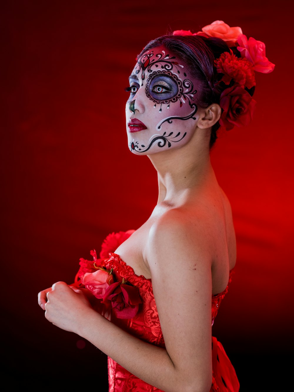 woman in red floral dress with pink rose headdress