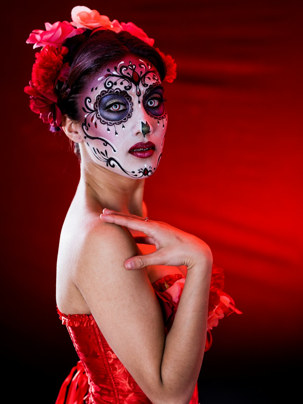 woman in red tube dress with face paint