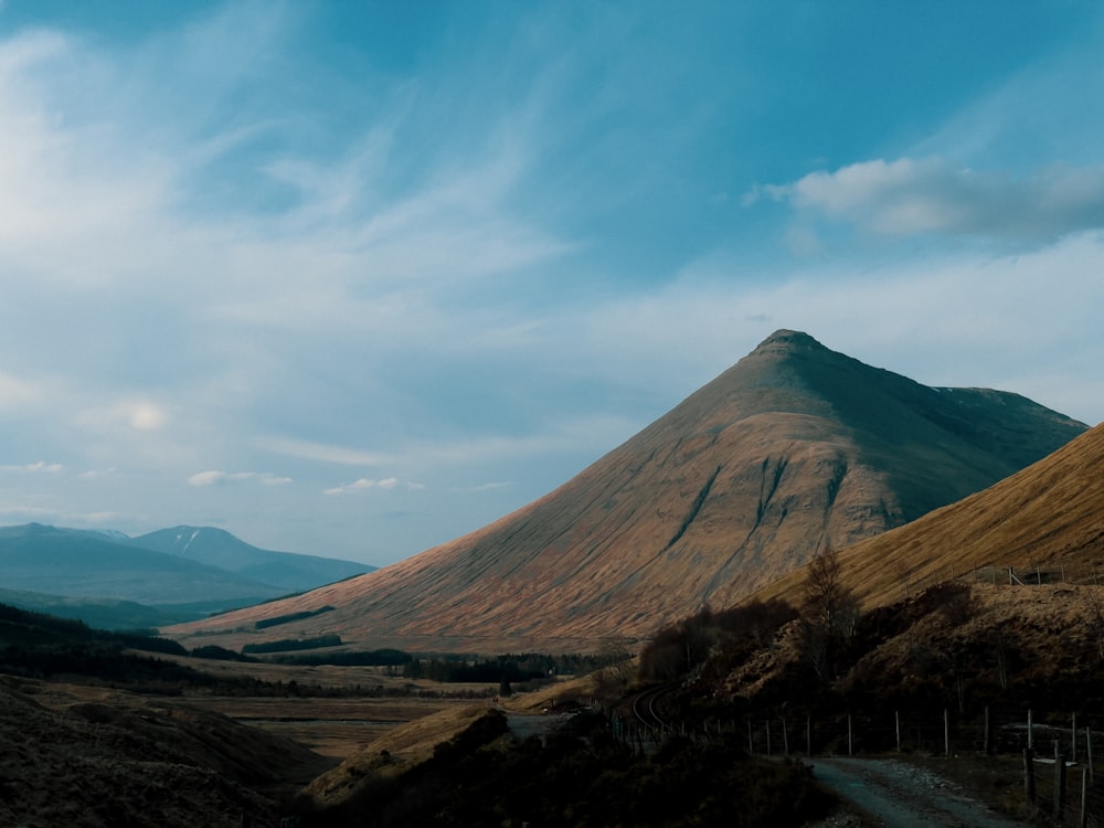 brown mountain under blue sky during daytime