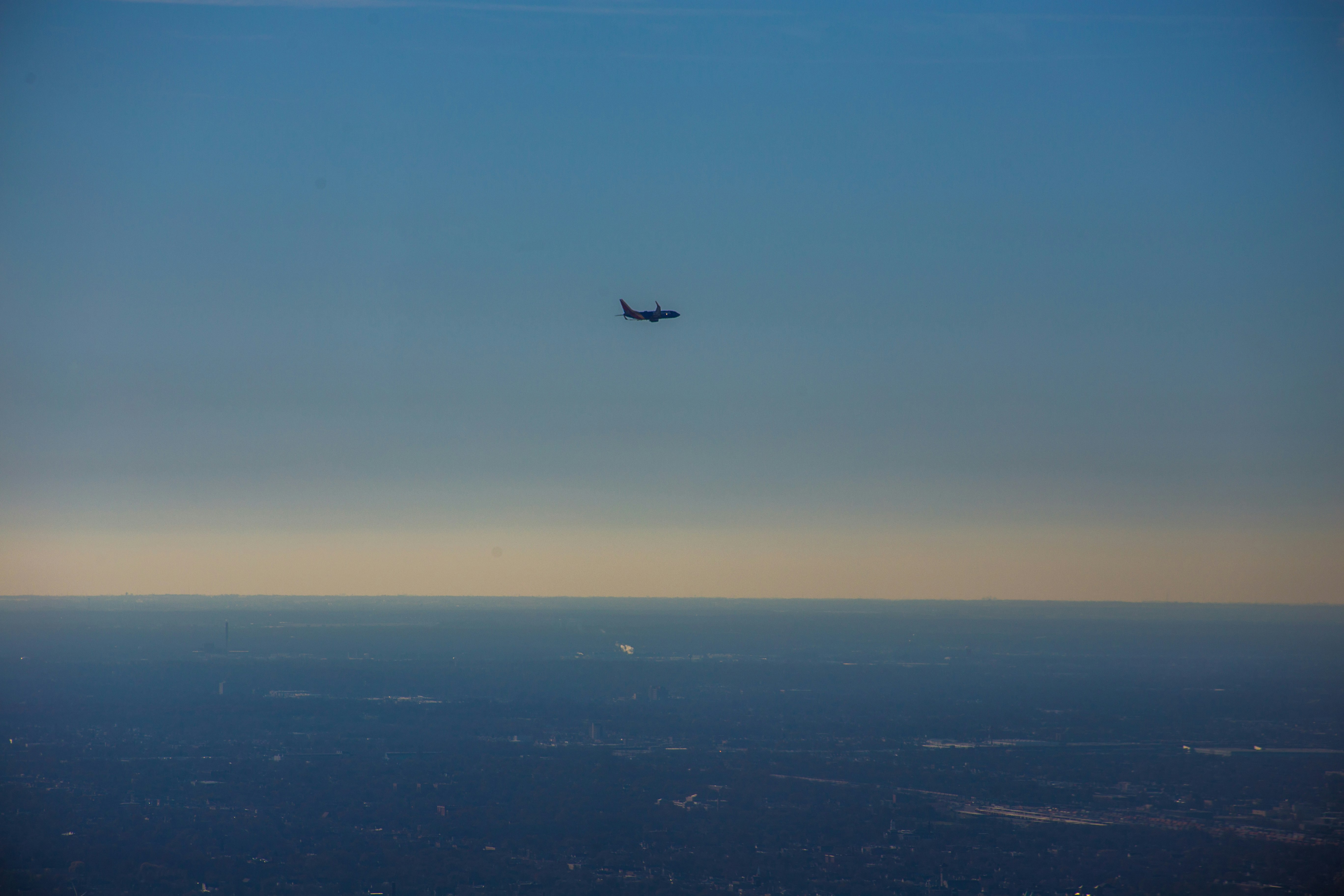 airplane in mid air during daytime