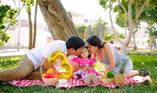 A family enjoying a picnic in a park, symbolizing love and protection.