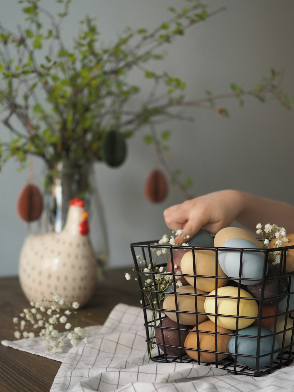 white egg in black metal basket on white table cloth