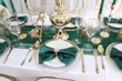 Luxurious table setting featuring black and gold cutlery with white plates