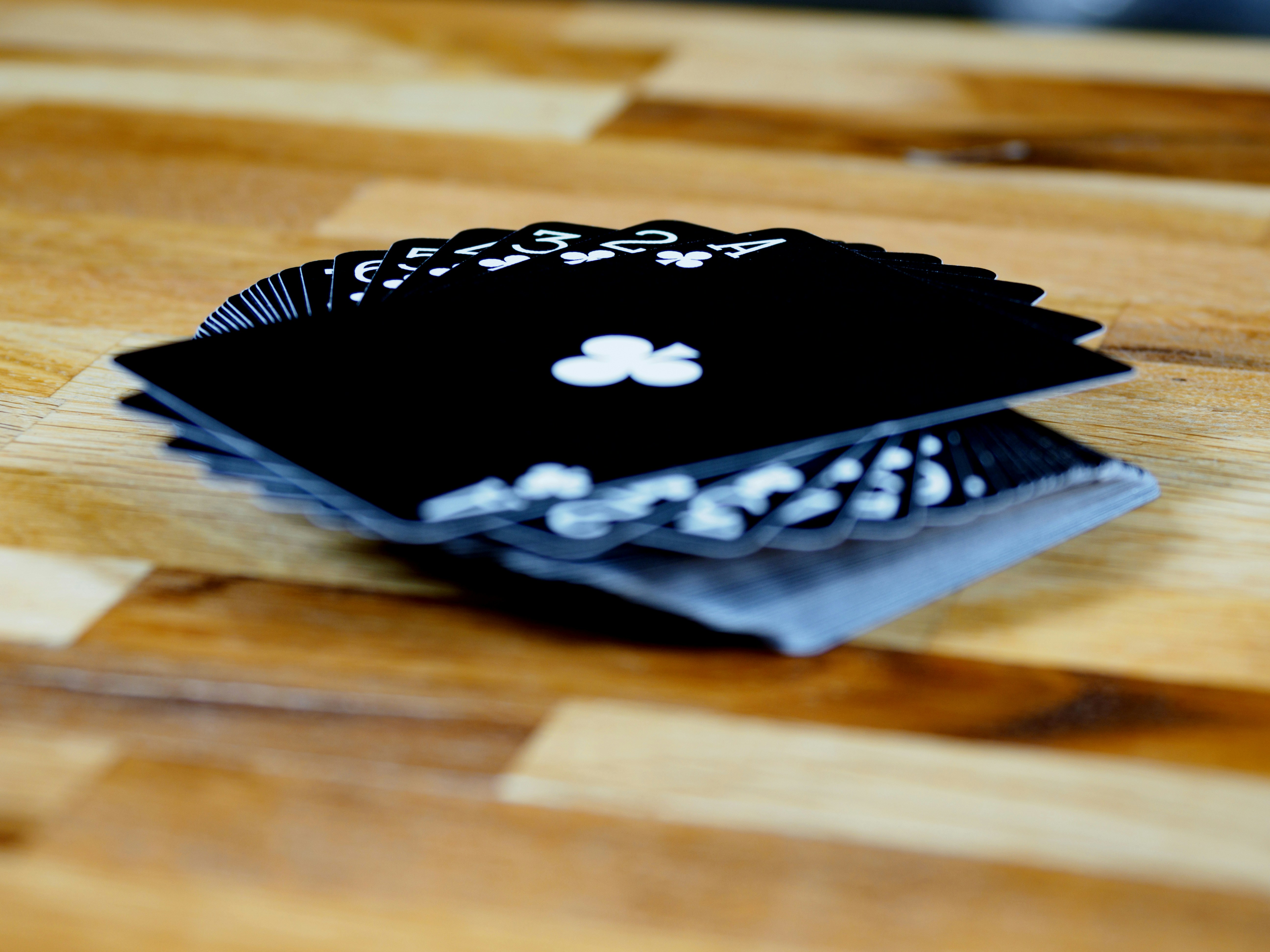 cards, playing cards, gambling, close up, bokeh, wood background, product shot, focus, deal,