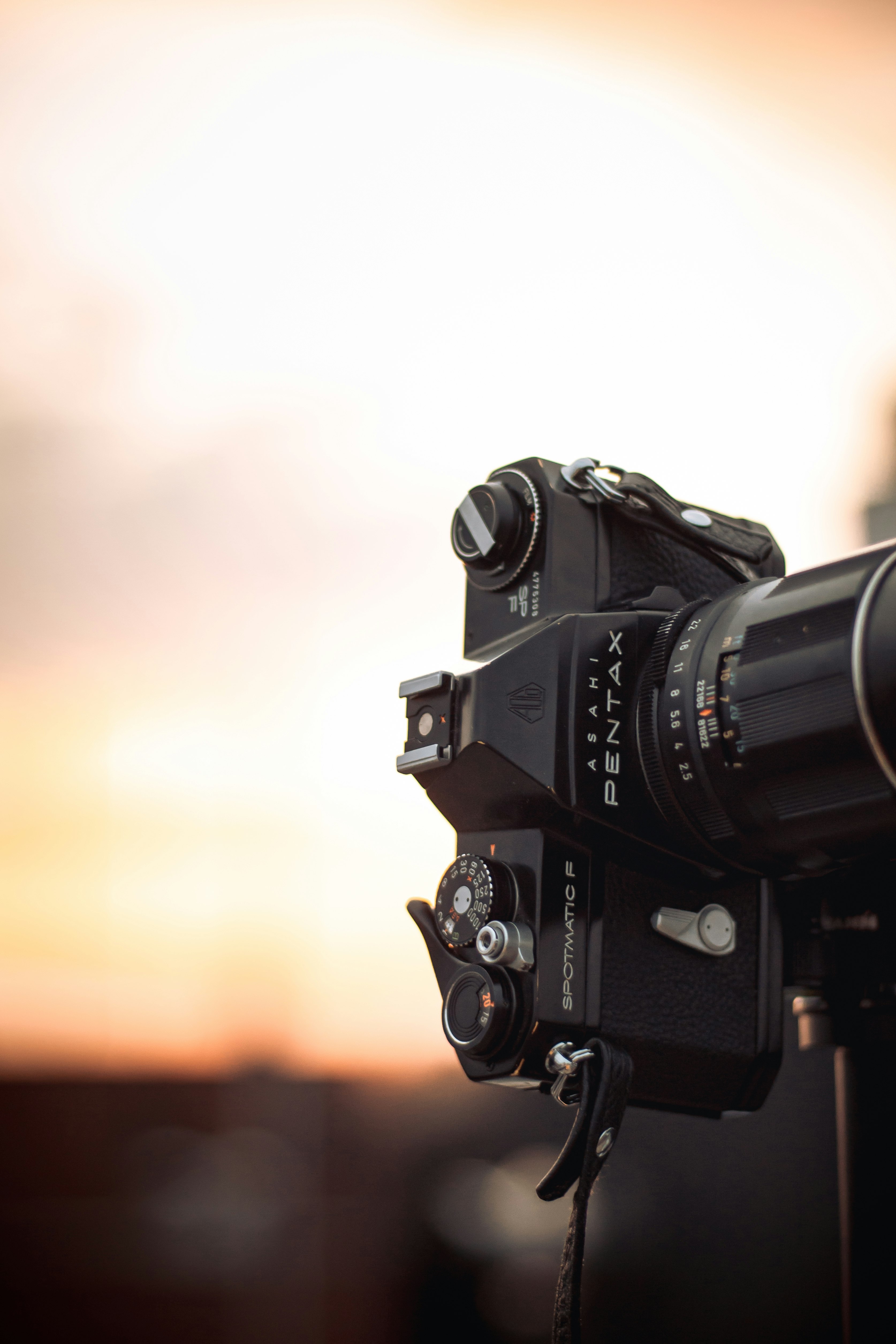 black dslr camera on brown wooden table