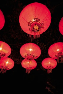 Traditional Chinese lanterns glowing warmly during a night festival.