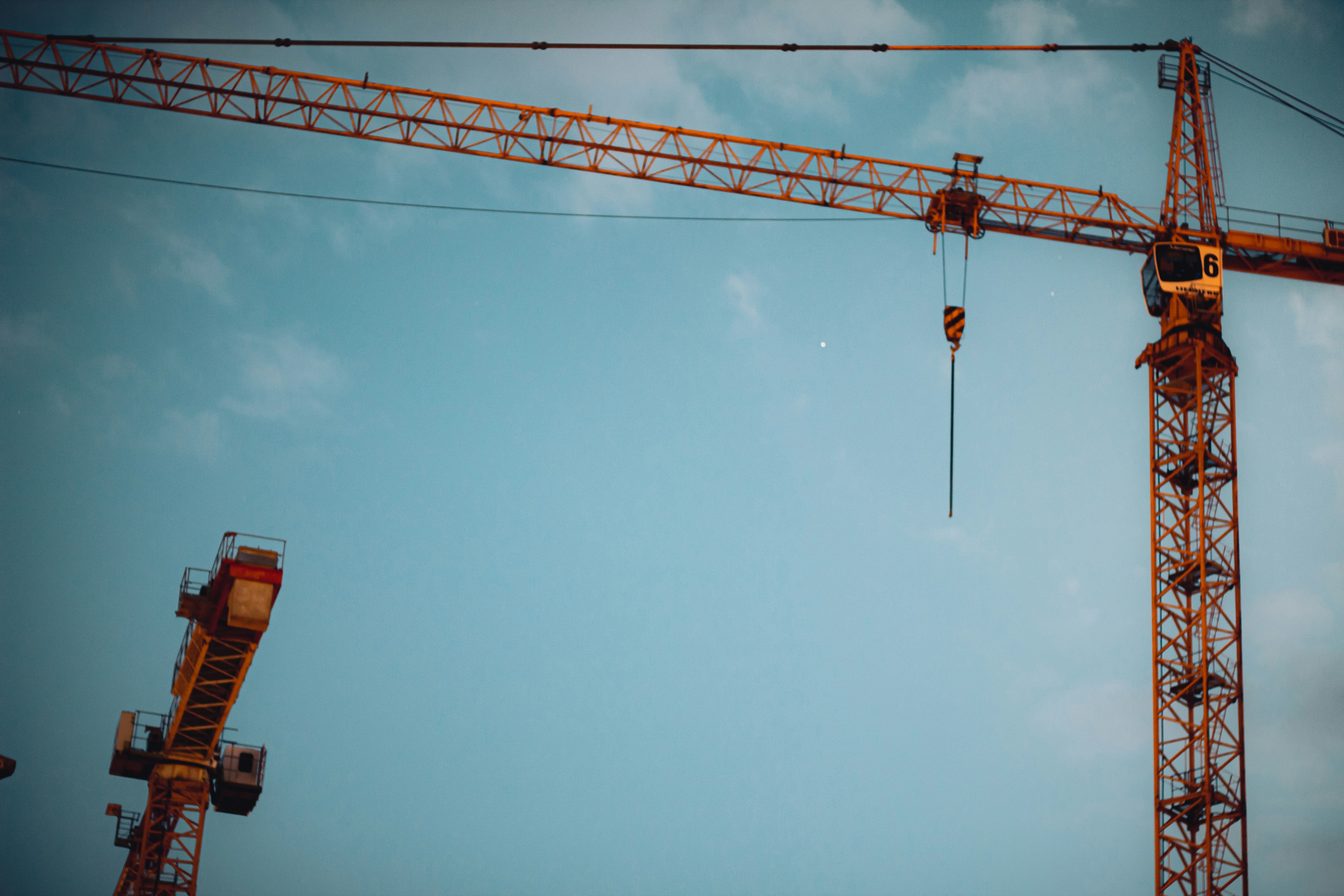 orange crane under blue sky