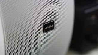 Close-up of a powerful subwoofer speaker cone with brand logo visible
