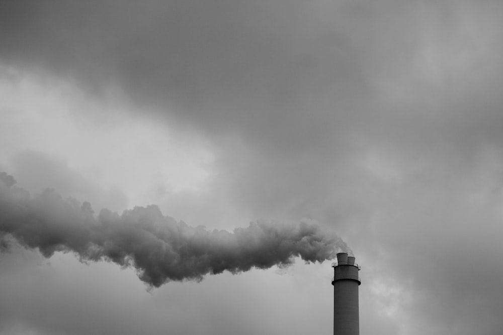 white and black lighthouse under white clouds