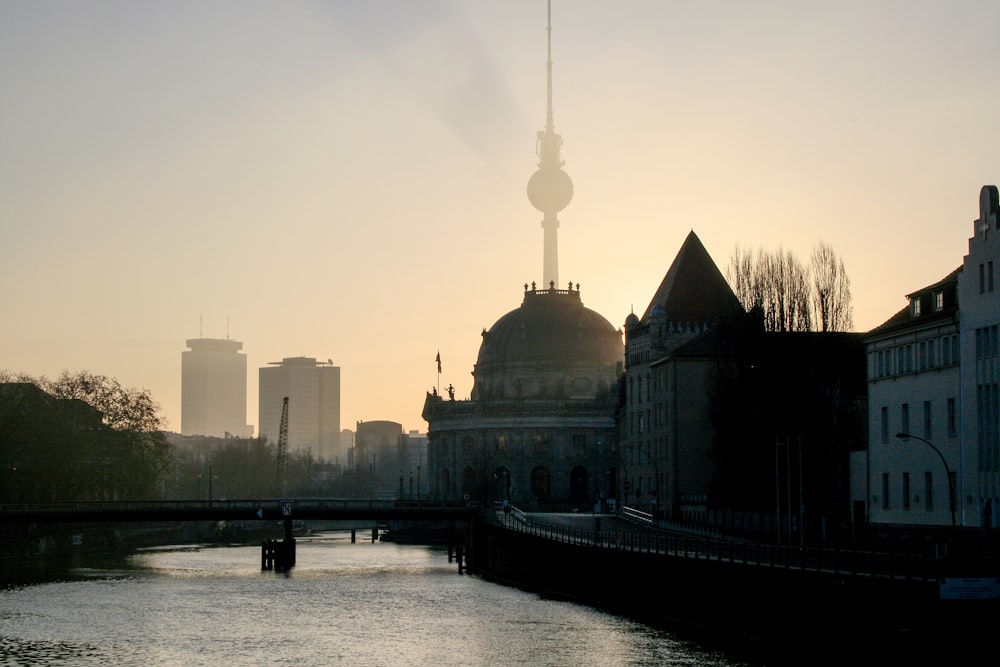 silhouette of building near body of water during daytime