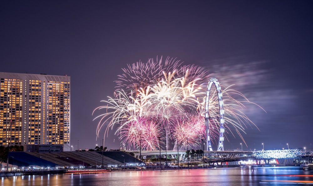 fireworks display over the river during night time