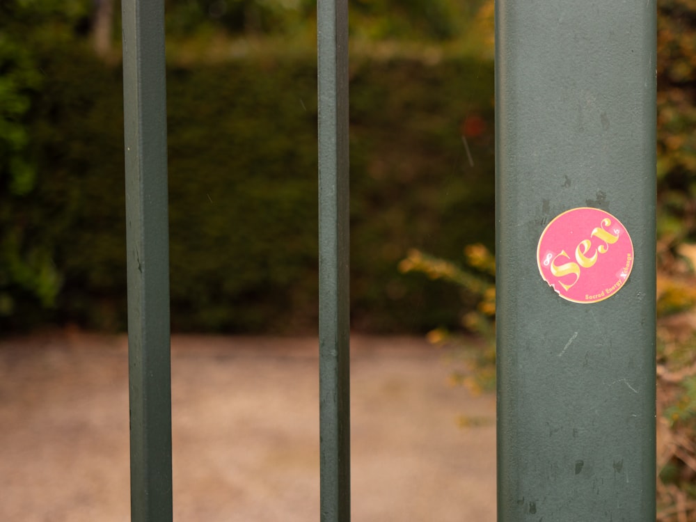 red and yellow heart sticker on gray metal fence