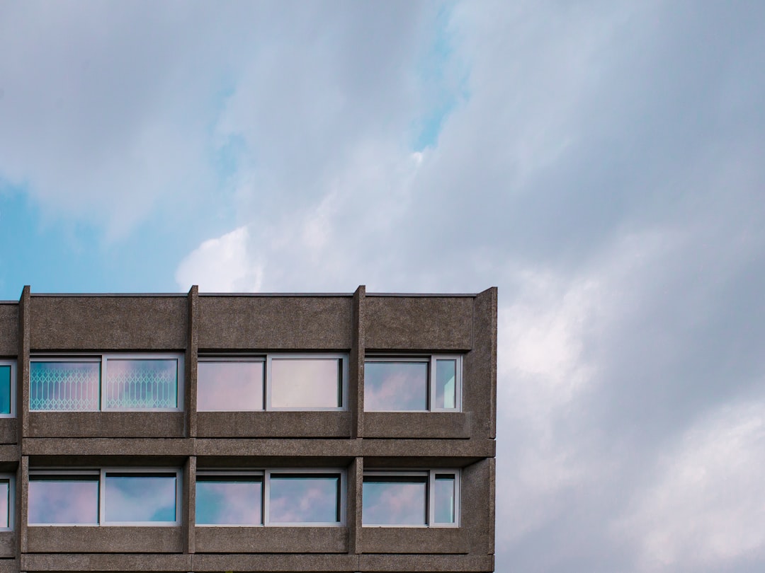 blue and white concrete building under white clouds during daytime