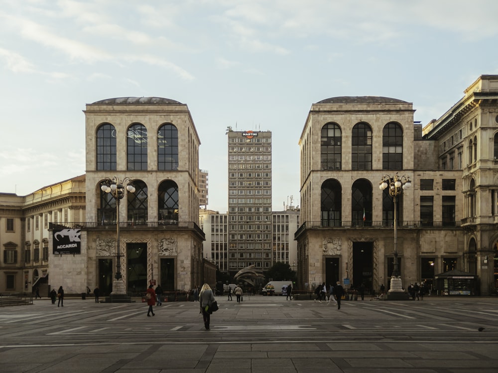 people walking on pedestrian lane near brown concrete building during daytime