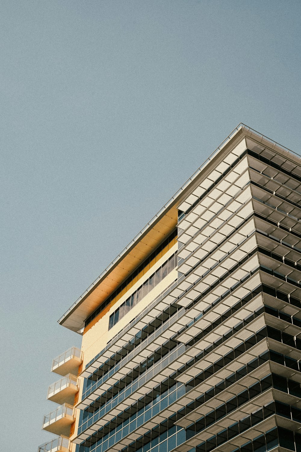 brown and white concrete building under blue sky during daytime