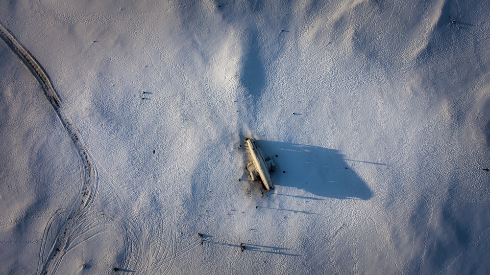 white boat on white sand during daytime