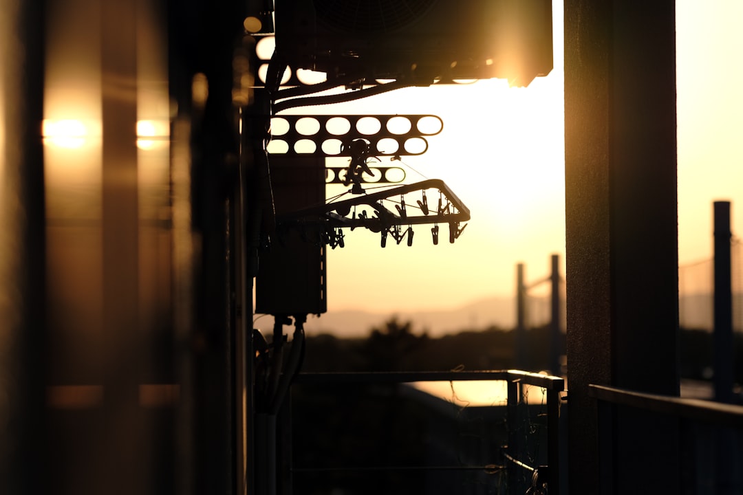 silhouette of man standing on window during sunset