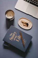 brown chopsticks on white ceramic round plate beside black book