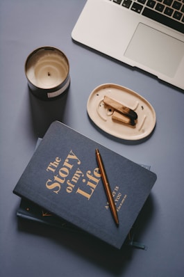 brown chopsticks on white ceramic round plate beside black book