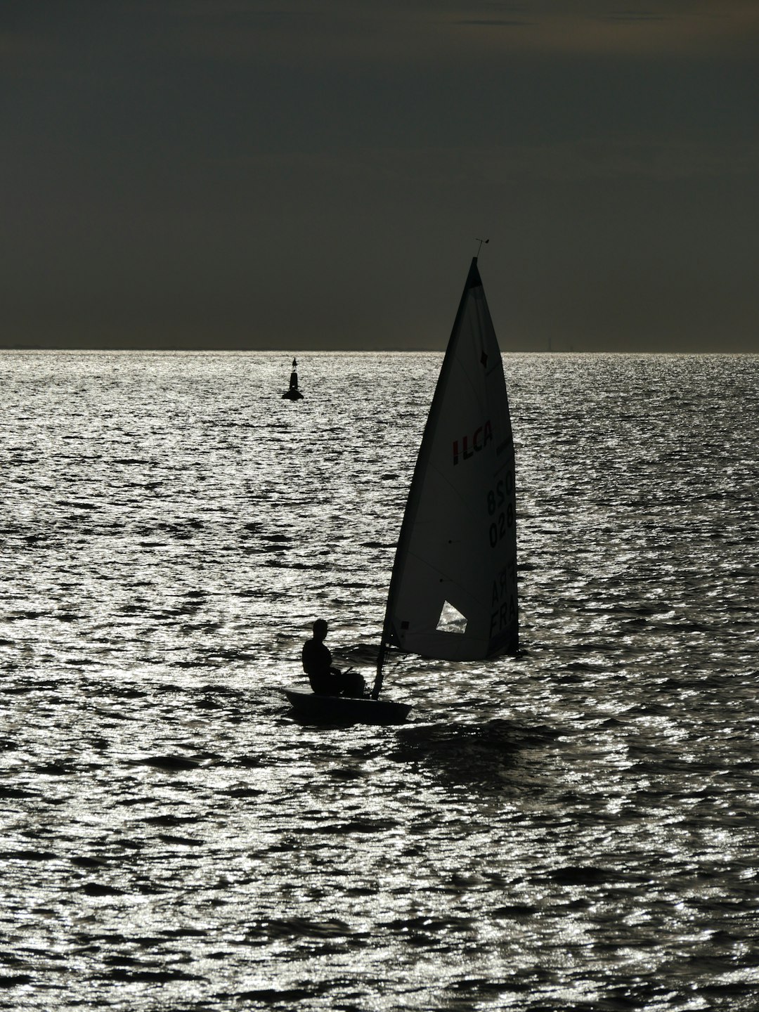 silhouette of person riding on sailboat on sea during daytime