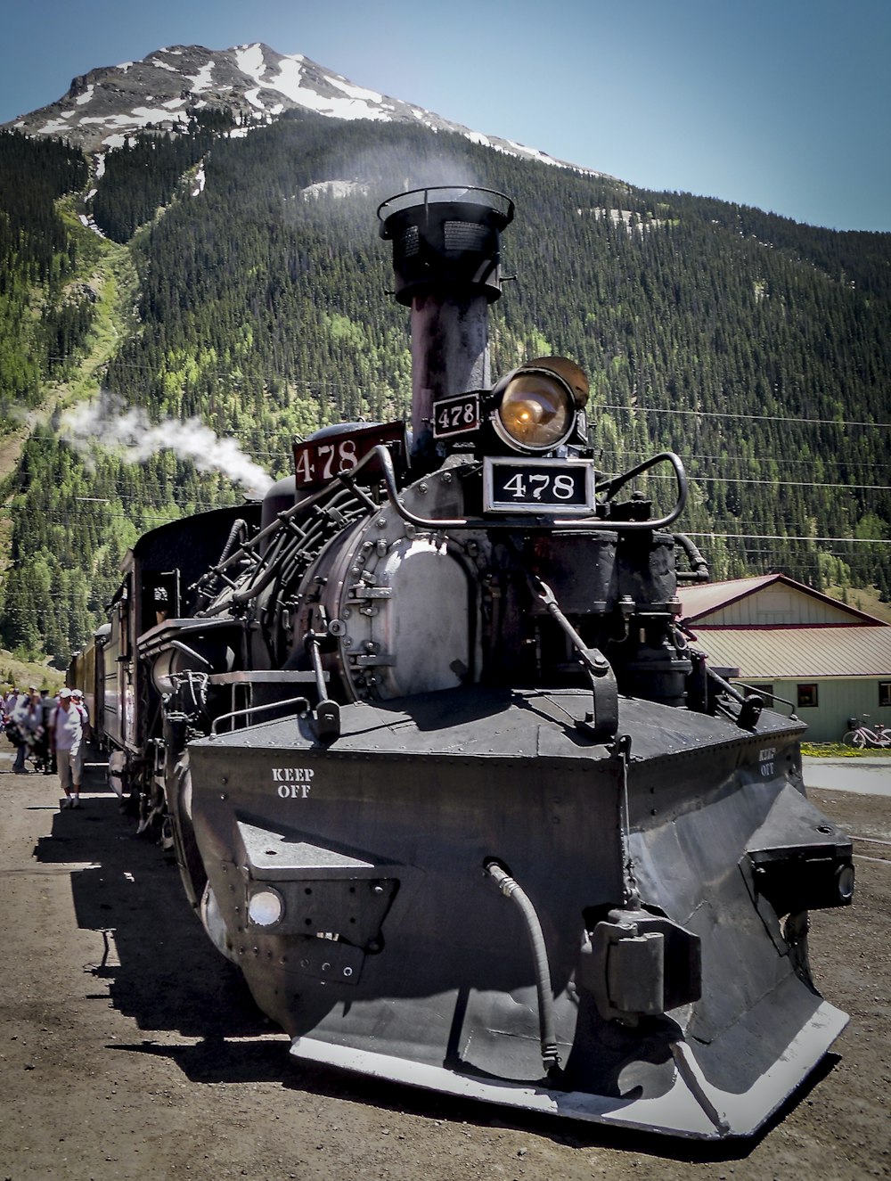 black and red train on rail tracks