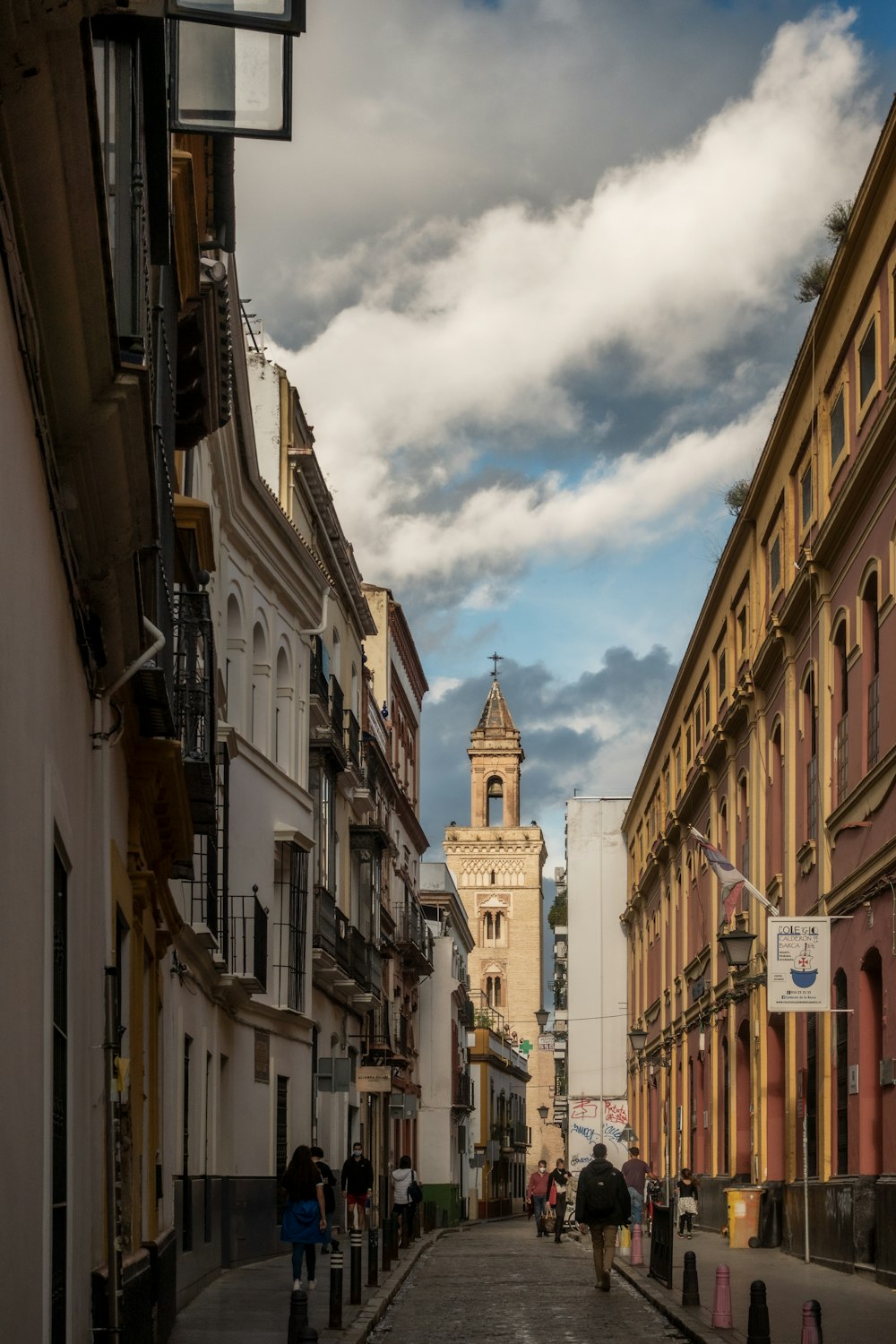 brown concrete buildings under white clouds during daytime