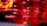 A close-up view of a server room or data center with bright red LED lights. The lights form various technical terms, suggesting network or server activity. The background is dark, highlighting the vibrant, dynamic lines and letters.