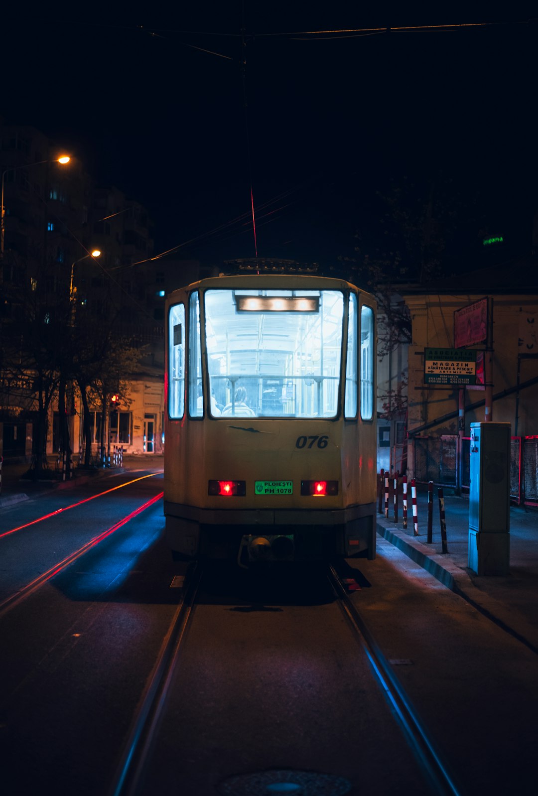 white and brown train on rail during night time