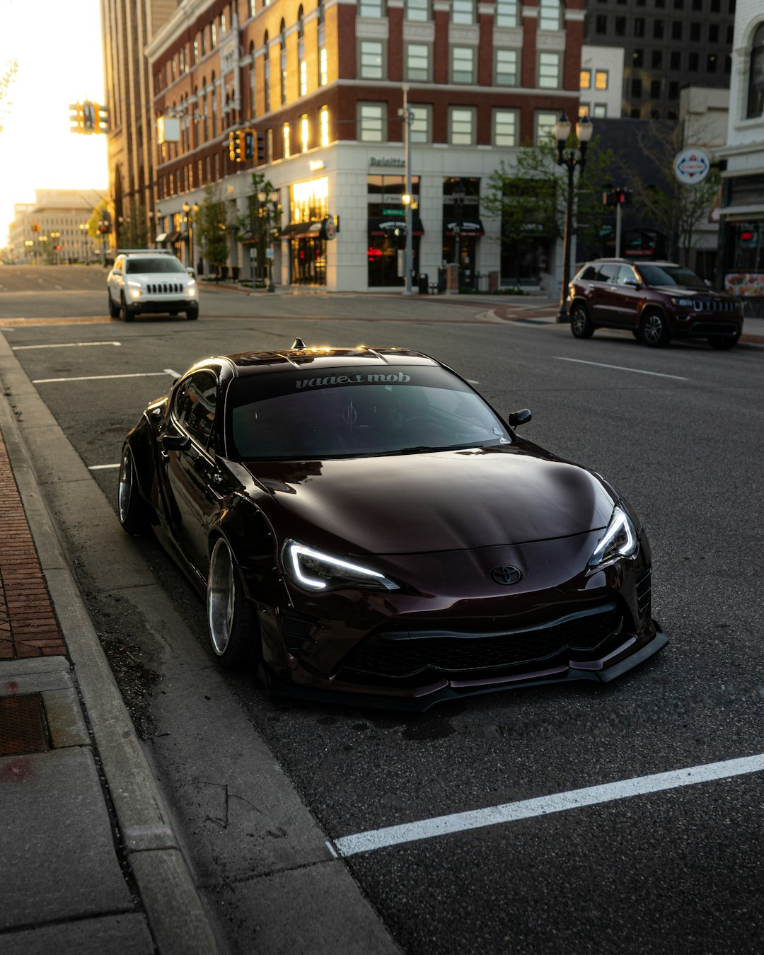 black porsche 911 parked on sidewalk during night time