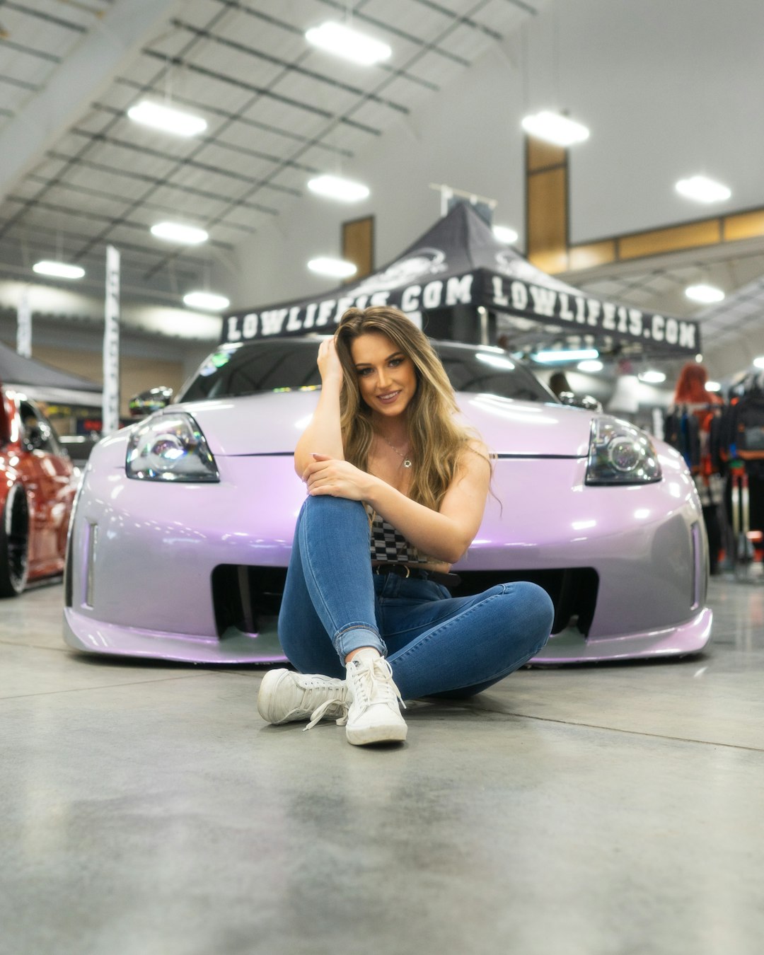 woman in blue denim jeans sitting on purple car