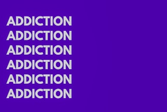 The image features the word 'ADDICTION' repeated six times vertically in bold, white capital letters against a solid purple background.