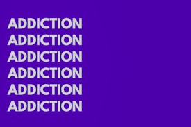 The image features the word 'ADDICTION' repeated six times vertically in bold, white capital letters against a solid purple background.