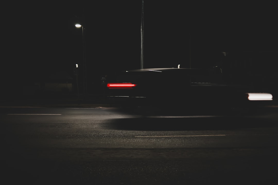 black car on road during night time