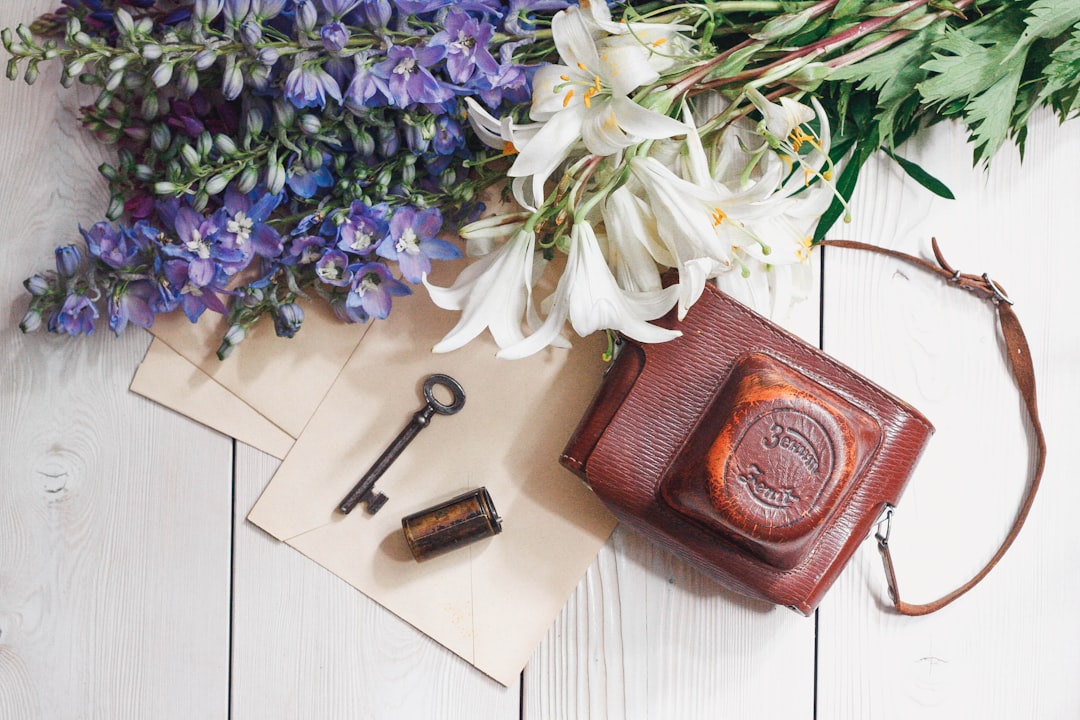 purple and white flowers on brown leather wallet