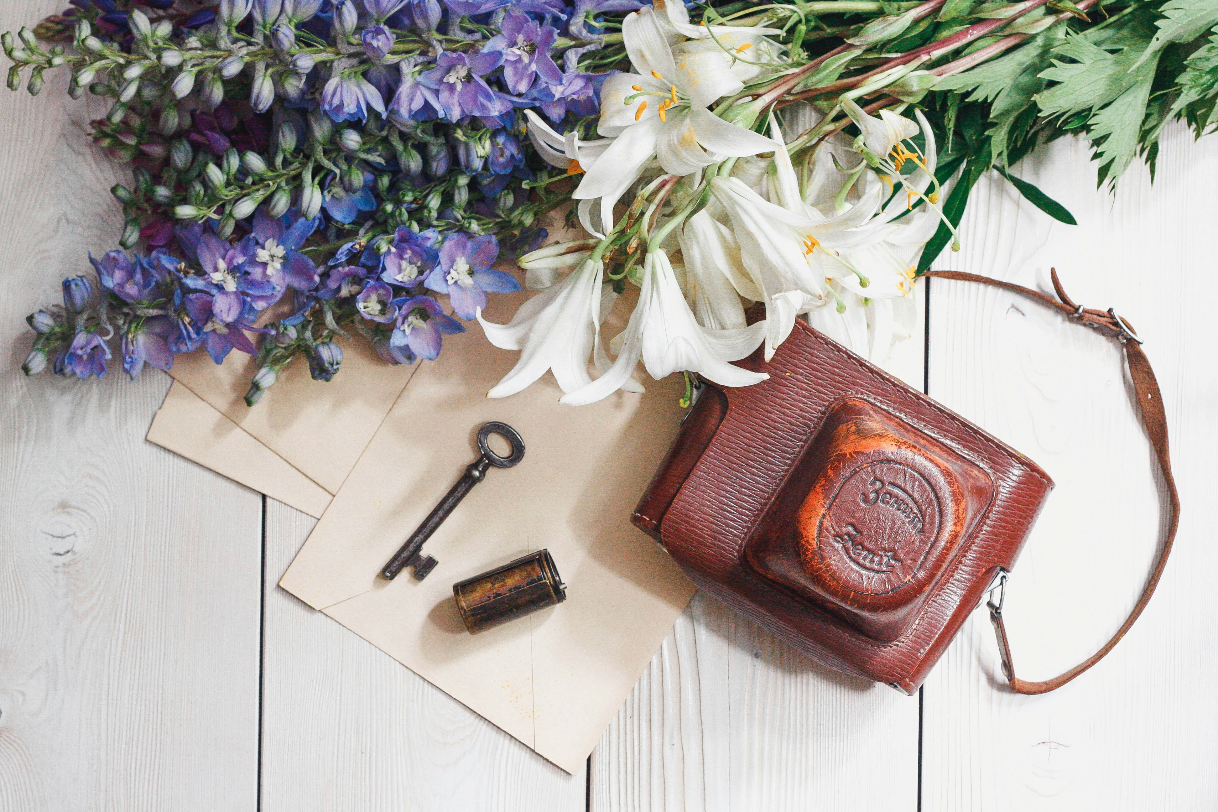 purple and white flowers on brown leather wallet