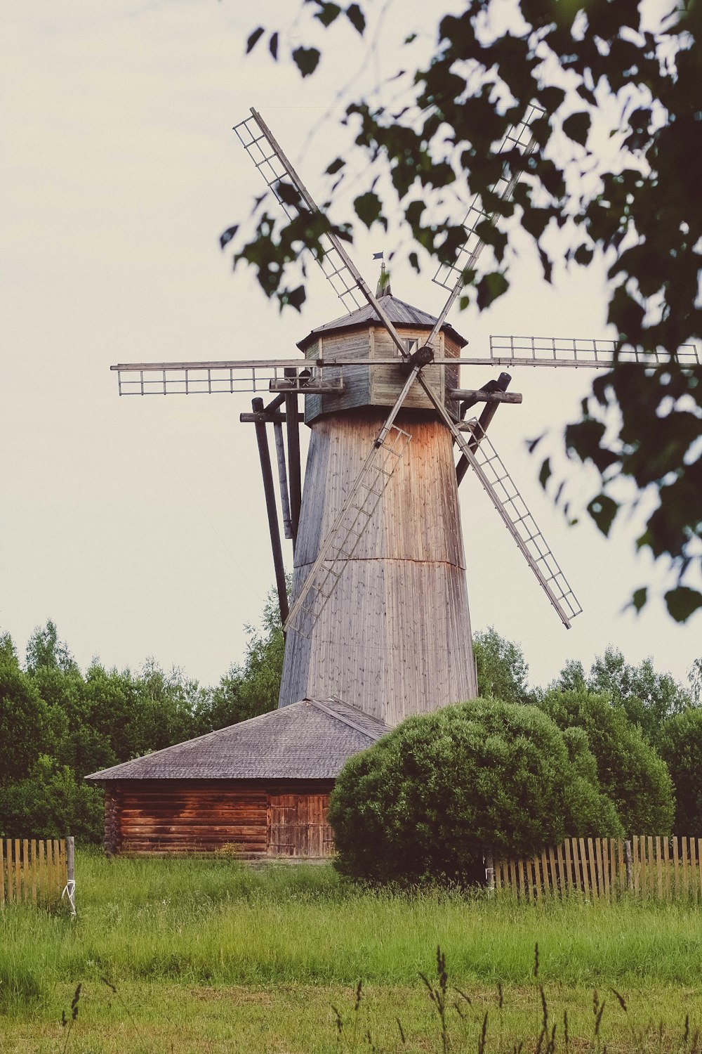 brown wooden house near green trees during daytime