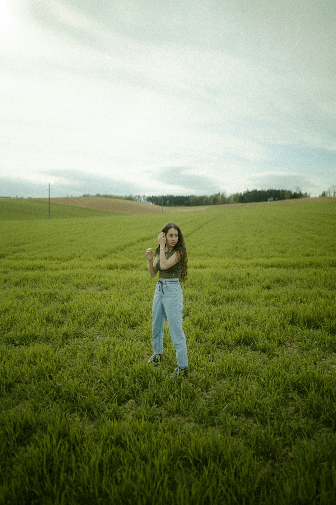 woman in black long sleeve shirt standing on green grass field during daytime