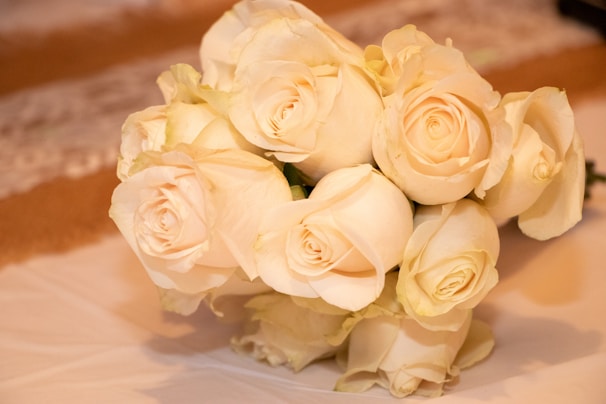 Finished bouquet resting on a soft cream surface, emphasizing the intricate details and softness of each bloom.