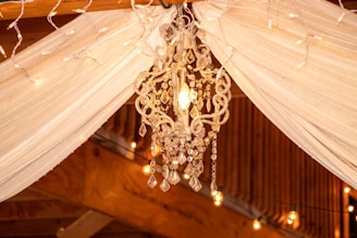 Elegant drapery and fairy lights creating a cozy atmosphere at an evening event.