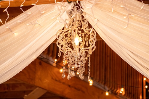 Elegant drapery and fairy lights creating a cozy atmosphere at an evening event.
