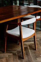 brown wooden table with white and brown chair